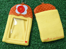 Load image into Gallery viewer, a custom felt ID badge holder designed like a dessert, featuring a yellow pudding or flan base, a brown top with a red button detail, and a photo slot in the center. the item is laid flat on a green artificial turf background. shows front and back.
