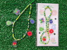 Load image into Gallery viewer, A beaded phone charm with colorful fruit-shaped charms, including a red apple, green pear, purple plum, a nostalgic picture book caterpillar character, and a nostalgic butterfly character

to the right is the same charm on a cute backing card packaging
