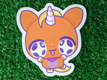 Load image into Gallery viewer, a die-cut sticker of a cute orange cartoon unicorn character with purple and yellow details
