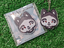 Load image into Gallery viewer, acrylic keychain showing a silly drawing of a creepypasta husky character smiling, showing silver chain and clear glossy epoxy coating shown with the cute backing card it comes on
